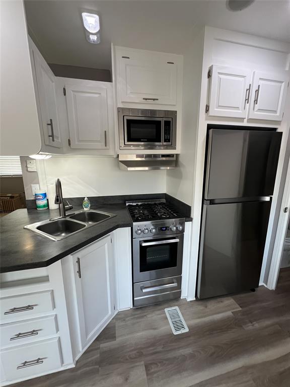 6501 Southeast 55th Lane, Unit 6501 Okeechobee, FL 34974 - Photo 6 of 15 a kitchen with granite countertop a sink stove and refrigerator