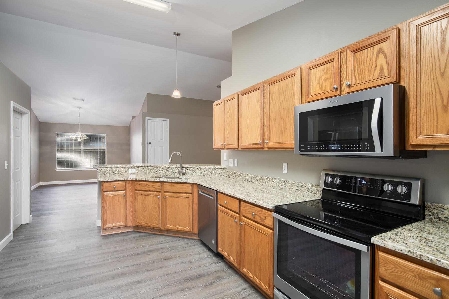 199 Bayou Landing Road Miramar Beach, FL 32550 - Photo 8 of 19 a kitchen with stainless steel appliances granite countertop wooden cabinets a stove a sink and a microwave