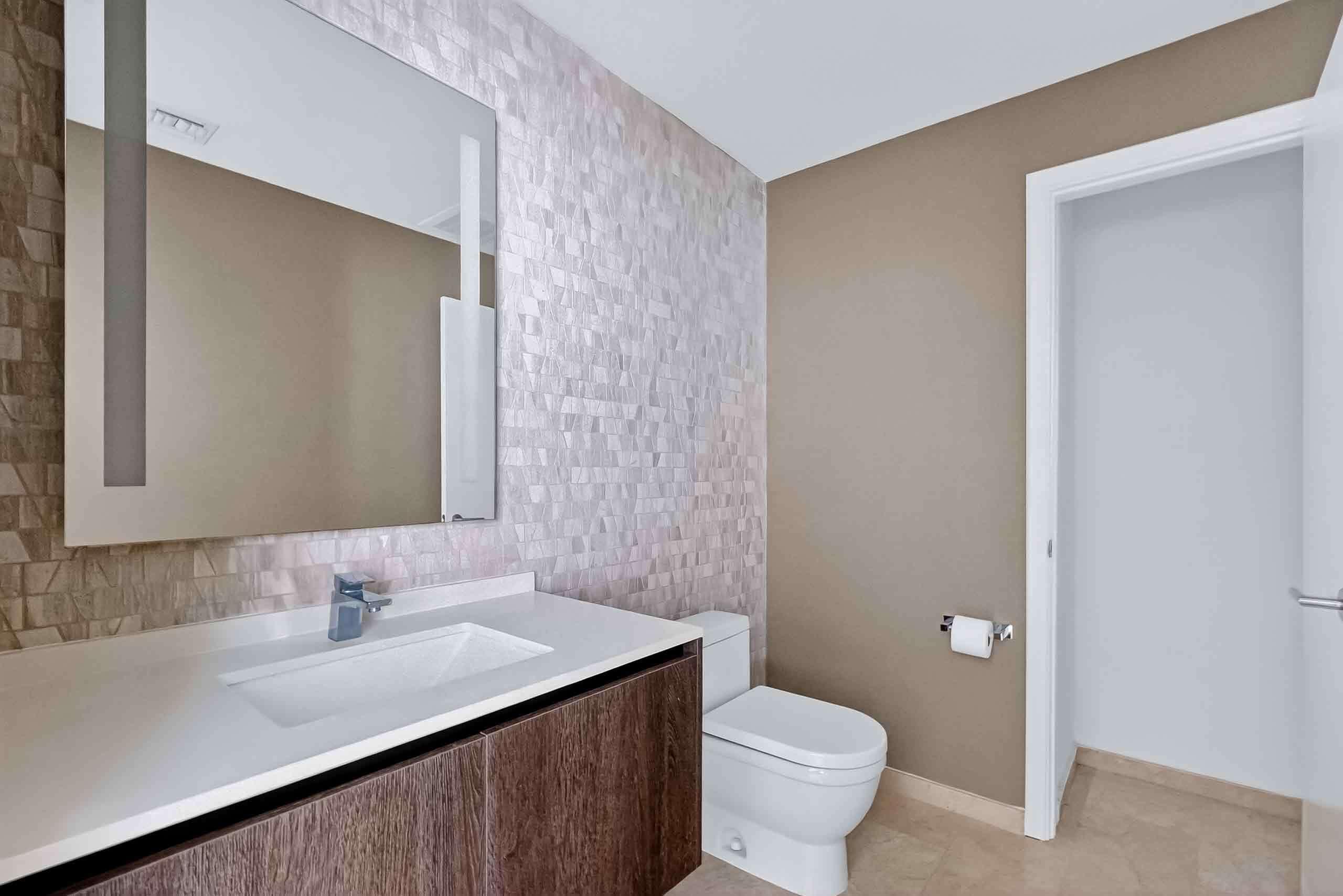 88 Southwest 7th Street, Unit 3003 Miami, FL 33130 - Photo 13 of 49 a bathroom with a granite countertop sink a toilet and a mirror