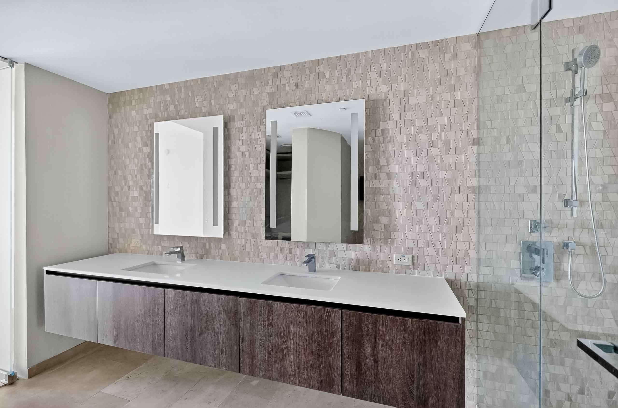 88 Southwest 7th Street, Unit 3003 Miami, FL 33130 - Photo 18 of 49 a bathroom with a double vanity sink and mirror