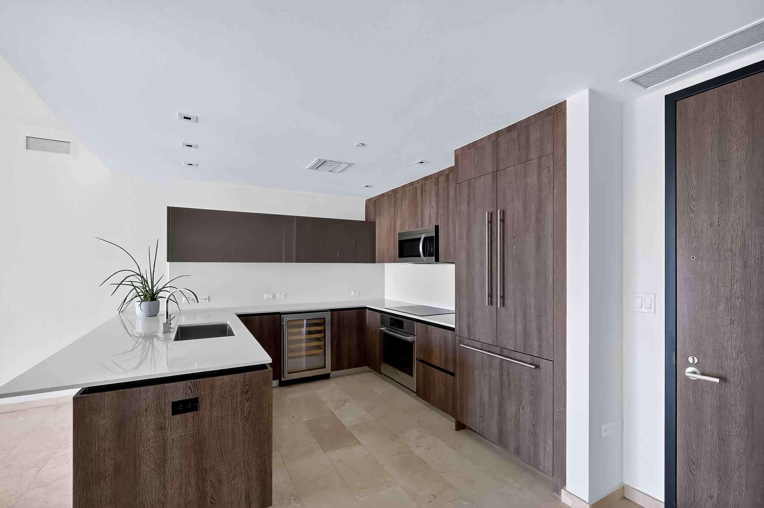 88 Southwest 7th Street, Unit 3003 Miami, FL 33130 - Photo 2 of 49 a kitchen with stainless steel appliances a sink and a refrigerator