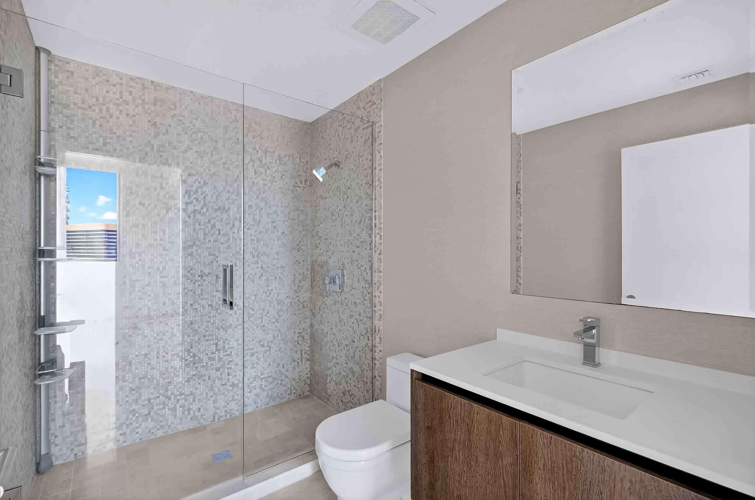 88 Southwest 7th Street, Unit 3003 Miami, FL 33130 - Photo 25 of 49 a bathroom with a sink a toilet and shower