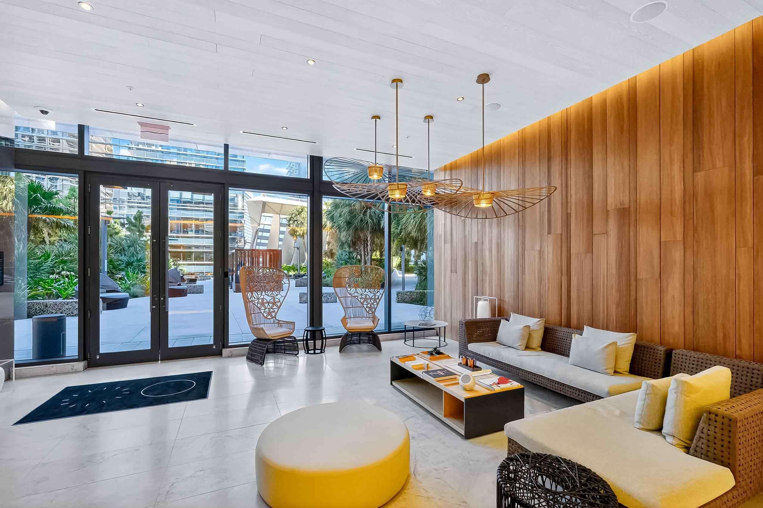 88 Southwest 7th Street, Unit 3003 Miami, FL 33130 - Photo 30 of 49 a living room with furniture and a floor to ceiling window