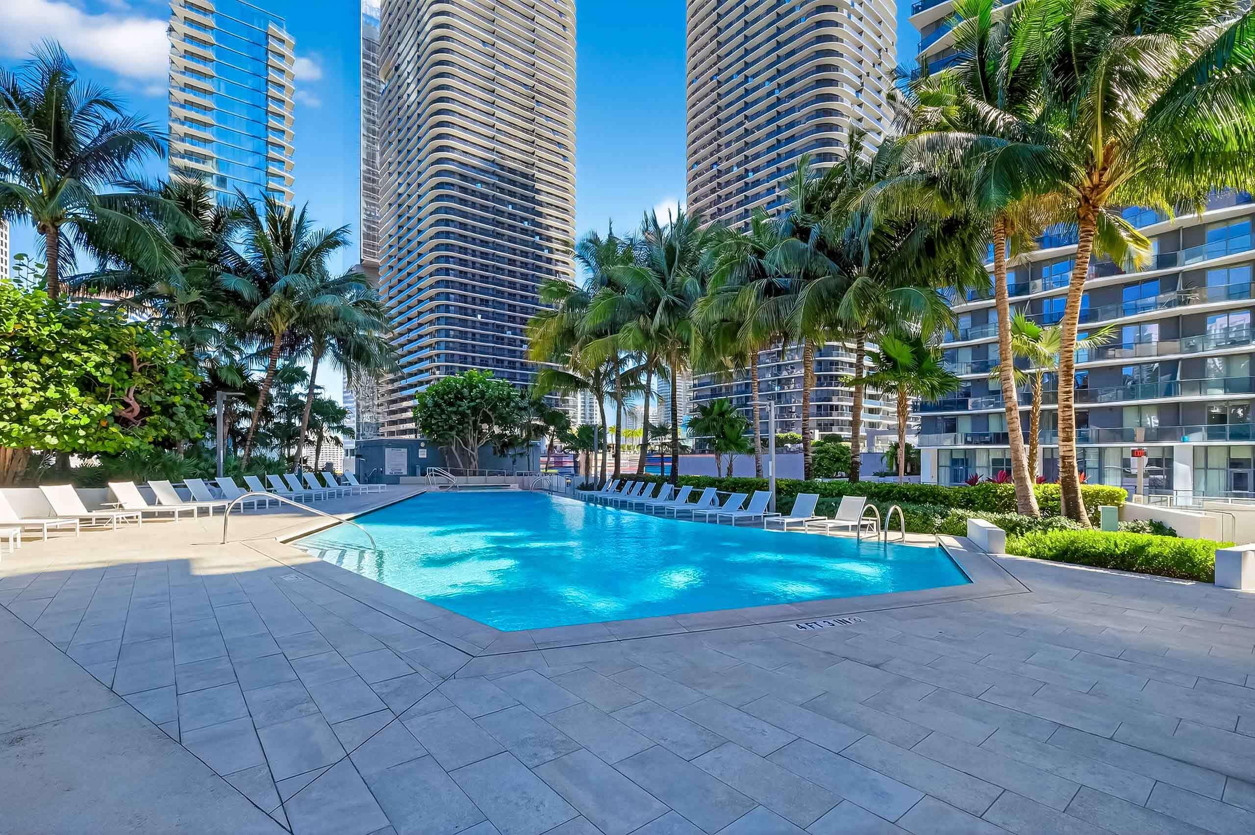 88 Southwest 7th Street, Unit 3003 Miami, FL 33130 - Photo 37 of 49 a swimming pool with outdoor seating and yard