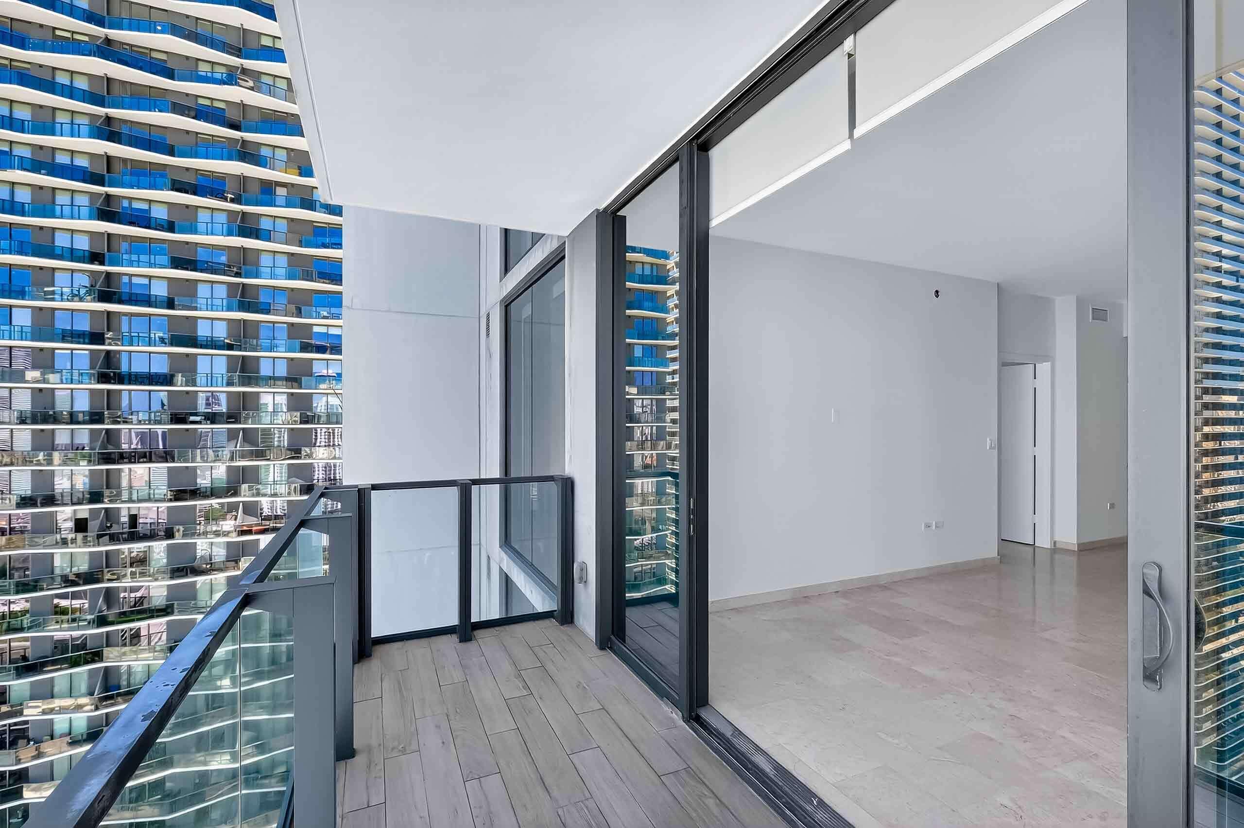 88 Southwest 7th Street, Unit 3003 Miami, FL 33130 - Photo 9 of 49 a view of a hallway with wooden floor and staircase