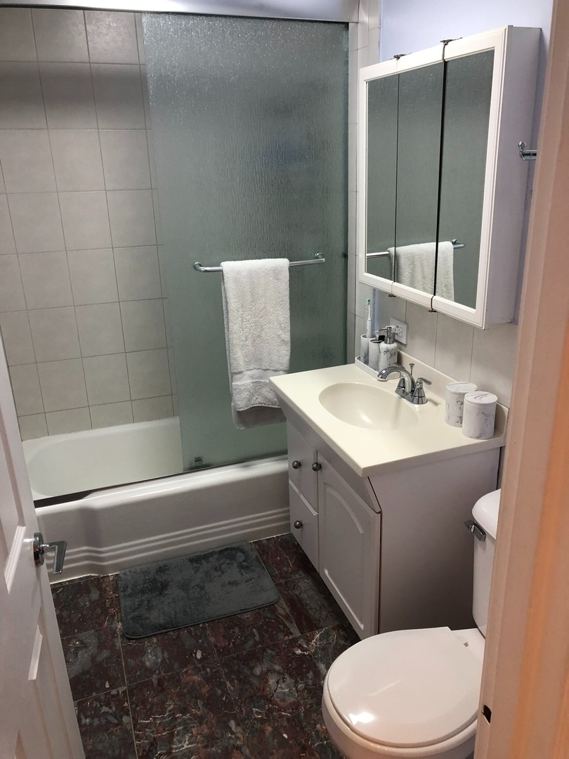 941 North Northwest Highway, Unit 3B Park Ridge, IL 60068 - Photo 18 of 26 a bathroom with a sink a toilet and shower