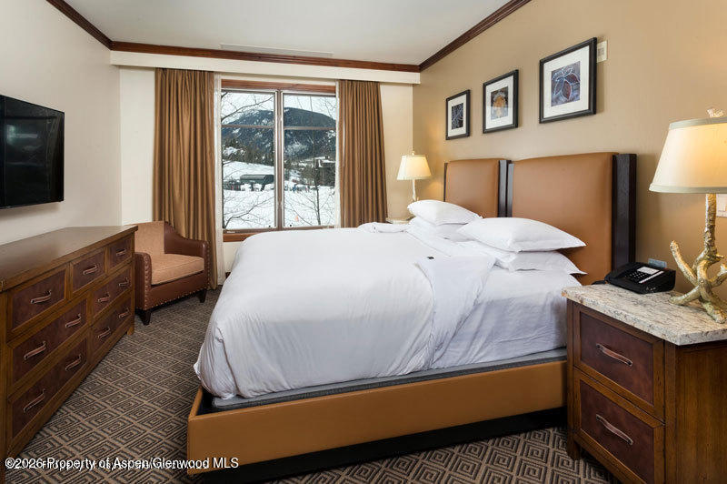 39 Boomerang Road, Unit 82098 Aspen, CO 81611 - Photo 6 of 17 a bedroom with a bed and a flat tv screen on dresser