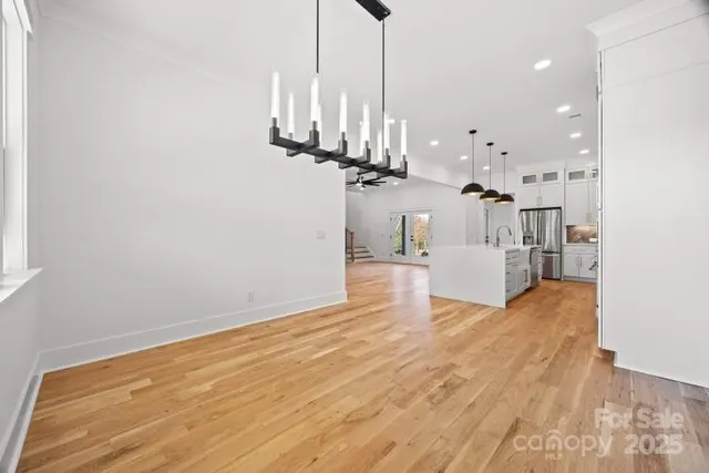 a view of kitchen and hall with wooden floor
