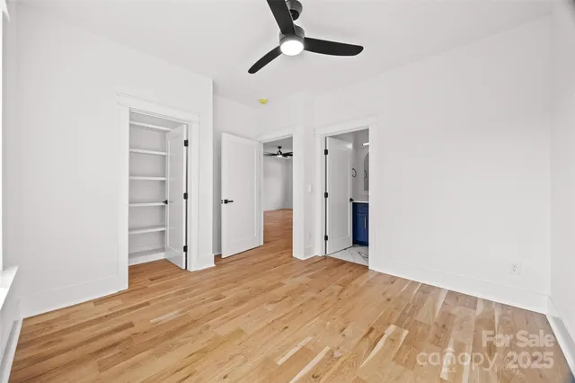 a bathroom with a toilet a sink a mirror a bathtub and vanity