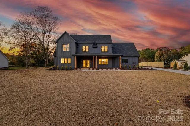 a view of a yard with a house in the background