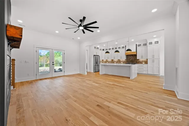 a view of a livingroom with a kitchen and wooden floor