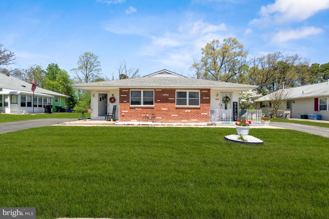 a front view of a house with a yard table and chairs