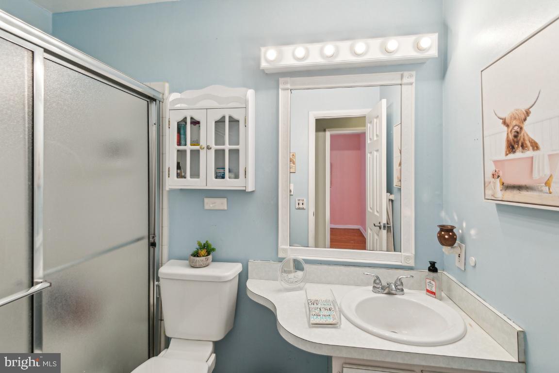 144 Elmtowne Boulevard Hammonton, NJ 08037 - Photo 11 of 25 a bathroom with a sink and a mirror