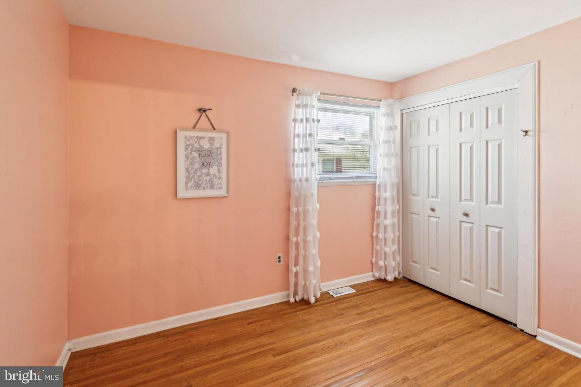 144 Elmtowne Boulevard Hammonton, NJ 08037 - Photo 12 of 25 an empty room with wooden floor and windows