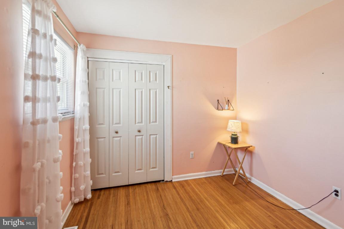 144 Elmtowne Boulevard Hammonton, NJ 08037 - Photo 13 of 25 a view of an empty room with wooden floor and a window