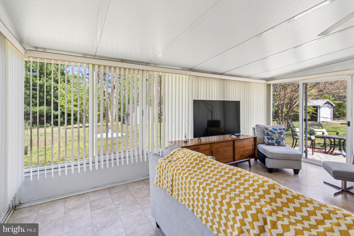 144 Elmtowne Boulevard Hammonton, NJ 08037 - Photo 19 of 25 a living room with furniture tv and a large window