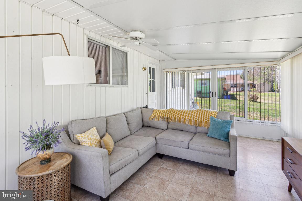 144 Elmtowne Boulevard Hammonton, NJ 08037 - Photo 21 of 25 a living room with furniture and a floor to ceiling window