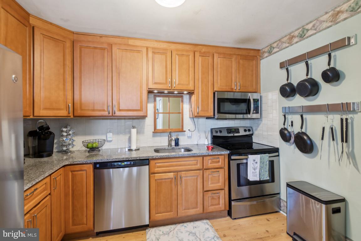 144 Elmtowne Boulevard Hammonton, NJ 08037 - Photo 9 of 25 a kitchen with stainless steel appliances granite countertop a stove a sink and a microwave