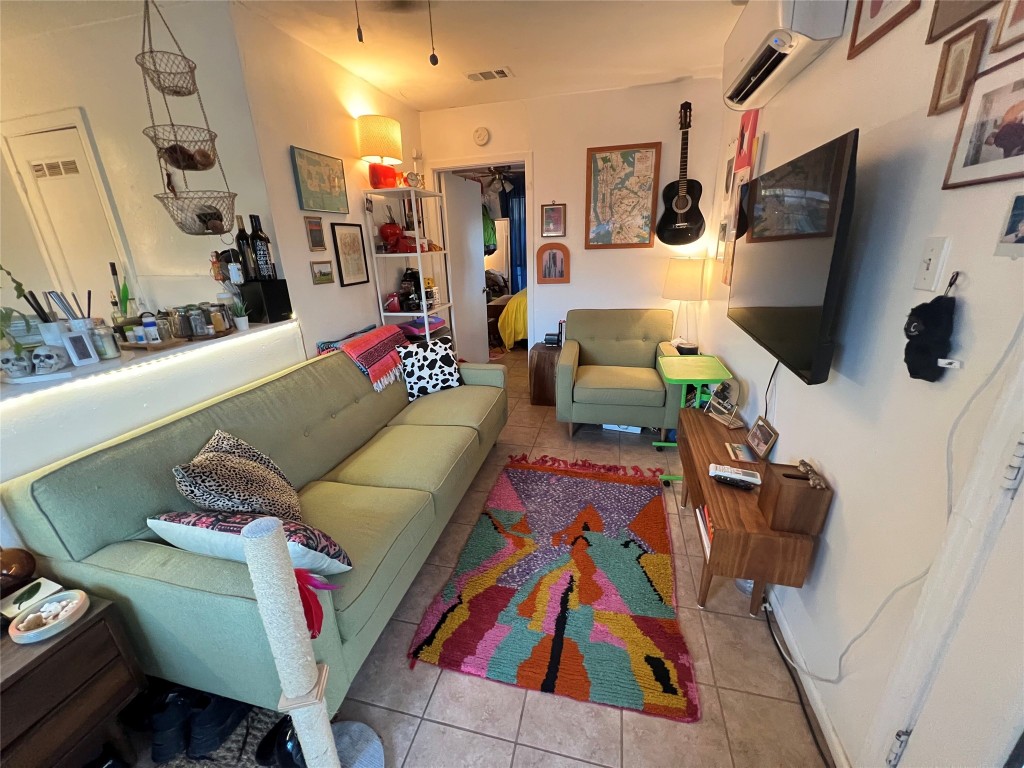 3318 Hemlock Avenue, Unit B Austin, TX 78722 - Photo 11 of 12 a living room with furniture and a flat screen tv