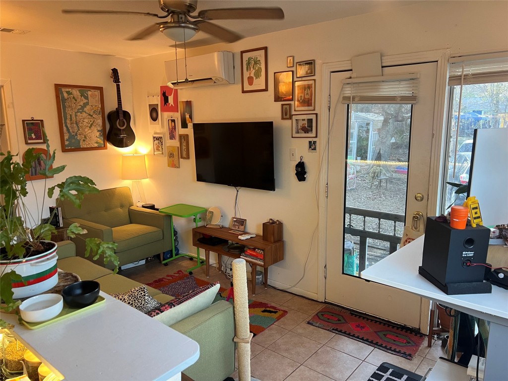 3318 Hemlock Avenue, Unit B Austin, TX 78722 - Photo 5 of 12 a living room with furniture and a flat screen tv