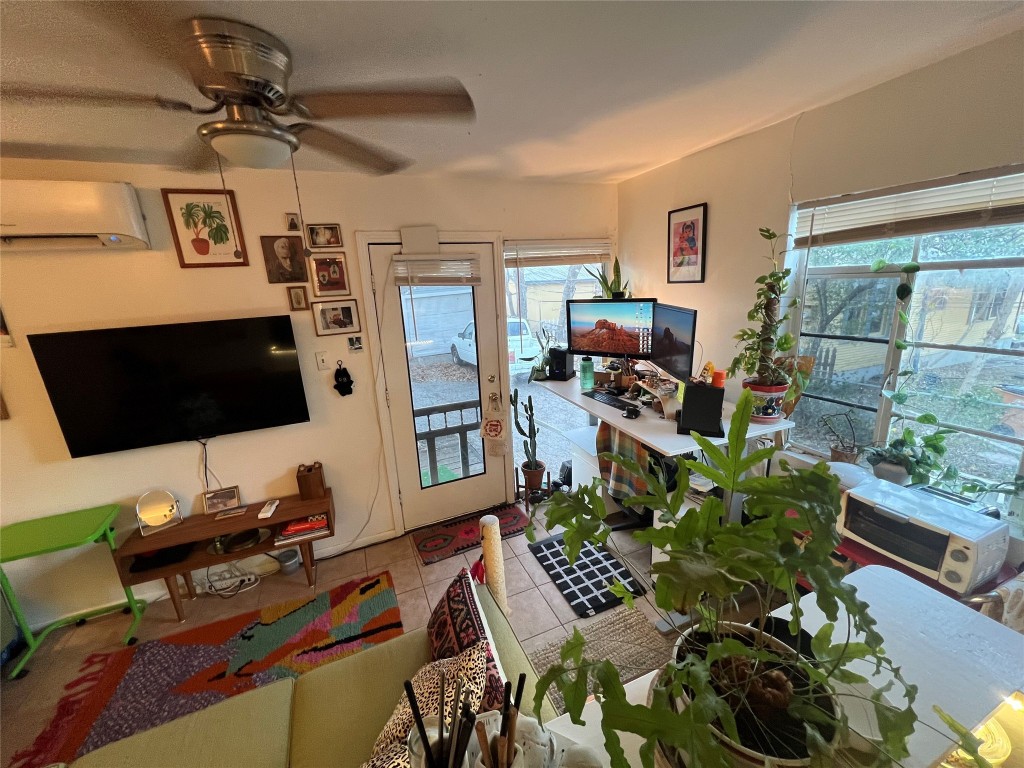 3318 Hemlock Avenue, Unit B Austin, TX 78722 - Photo 6 of 12 a work room with furniture and a flat screen tv