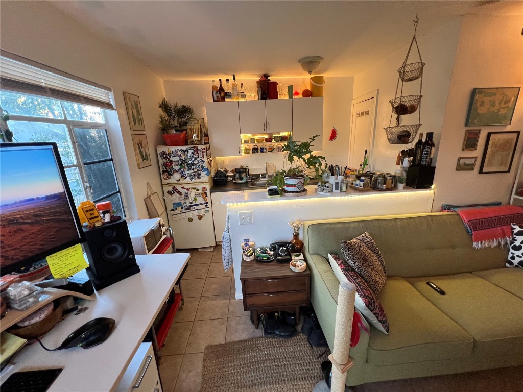 3318 Hemlock Avenue, Unit B Austin, TX 78722 - Photo 8 of 12 a living room with furniture and a flat screen tv