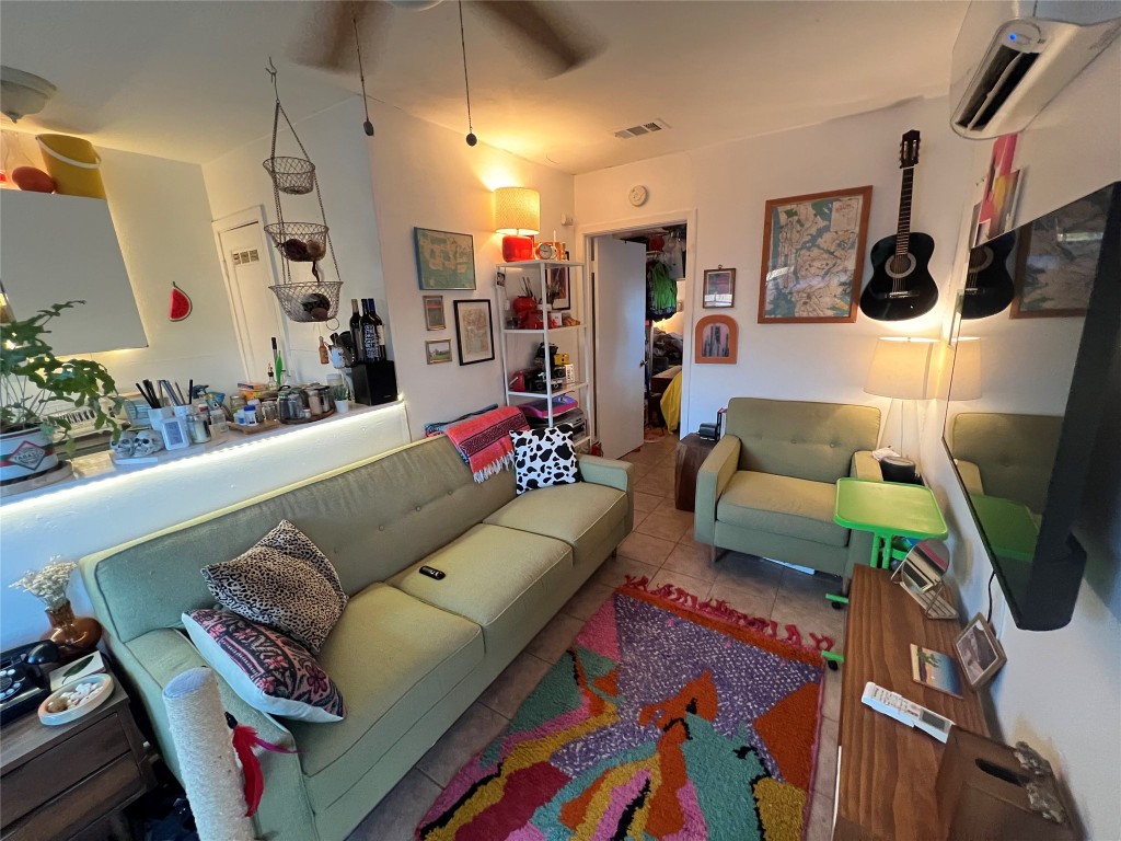 3318 Hemlock Avenue, Unit B Austin, TX 78722 - Photo 9 of 12 a living room with furniture and a flat screen tv