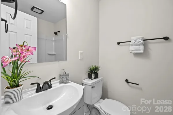 a bathroom with a sink toilet and a mirror