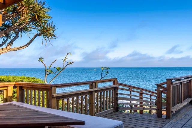 a view of a wooden deck with two chairs and a table