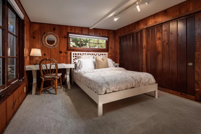 a bedroom with a bed and chair