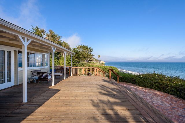 a view of a balcony with dining table and chairs with wooden floor