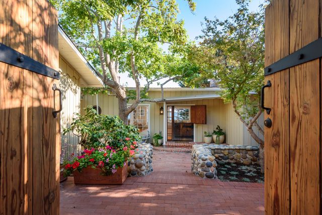 a view of a house with a backyard and a garden
