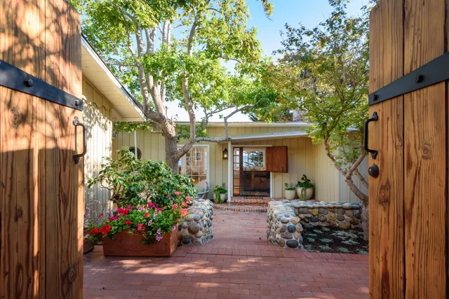 a view of a house with a backyard and a garden