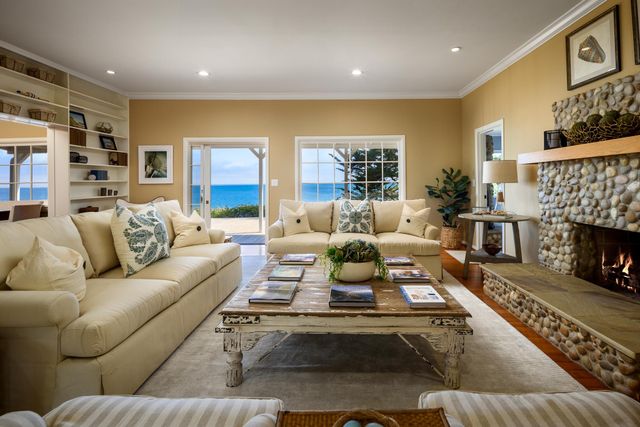 a living room with furniture fireplace and a table
