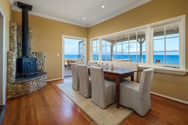 a living room with furniture a large window and wooden floor