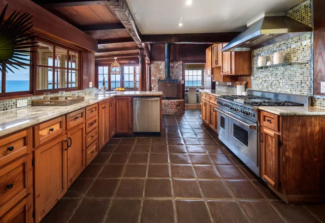 a large kitchen with stainless steel appliances and cabinets