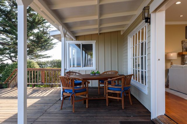 a view of a patio with a table chairs and a gate
