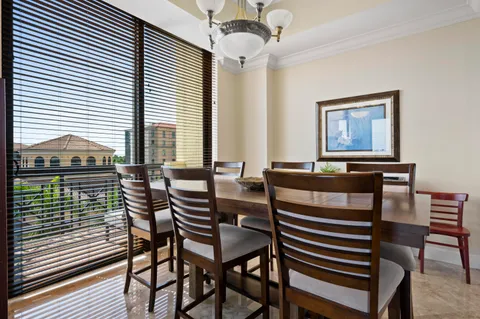 a view of a dining room with furniture a chandelier and wooden floor
