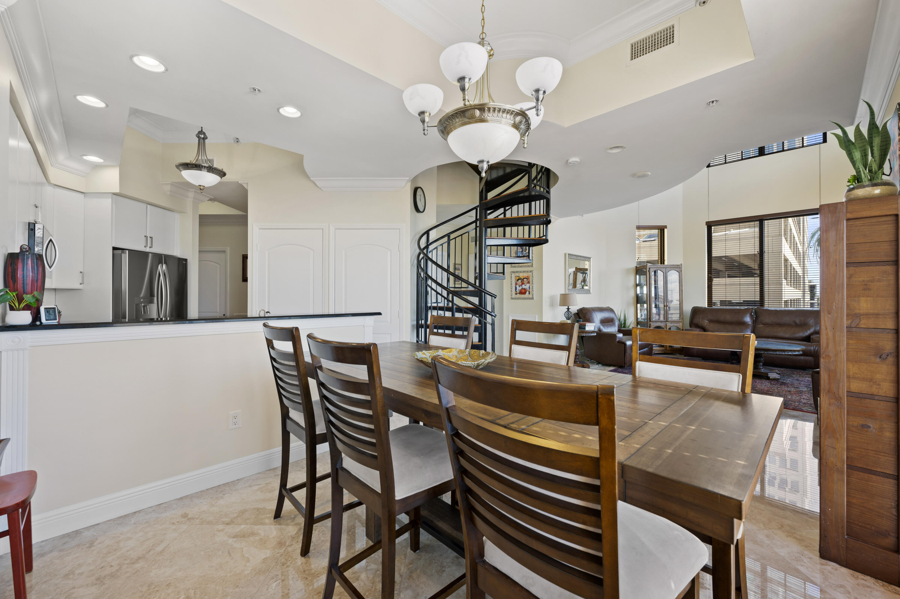 801 South Olive Avenue, Unit 416 West Palm Beach, FL 33401 - Photo 12 of 34 a view of a dining room with furniture a chandelier and wooden floor