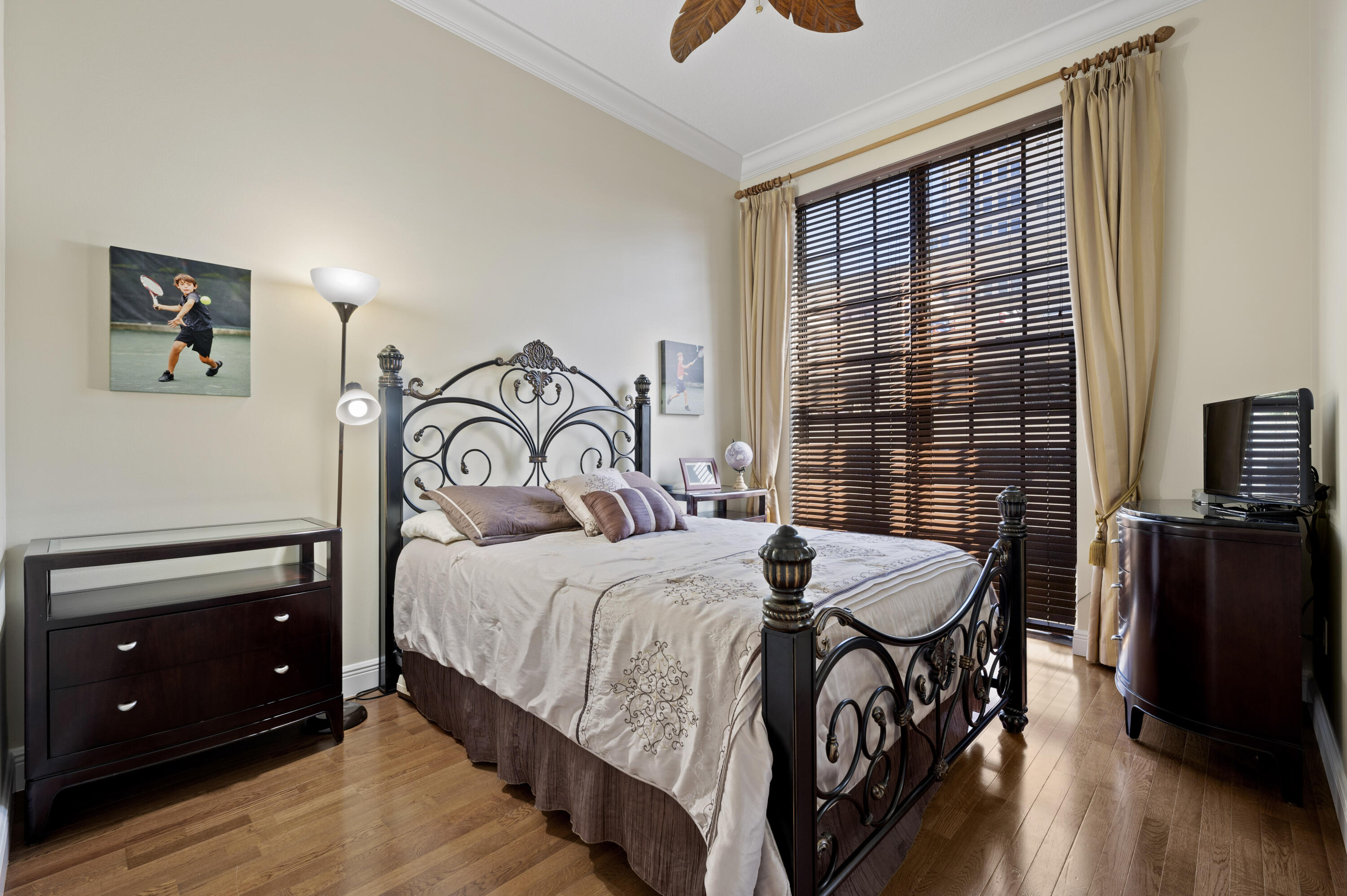 801 South Olive Avenue, Unit 416 West Palm Beach, FL 33401 - Photo 13 of 34 a bedroom with a bed and a flat tv screen on dresser