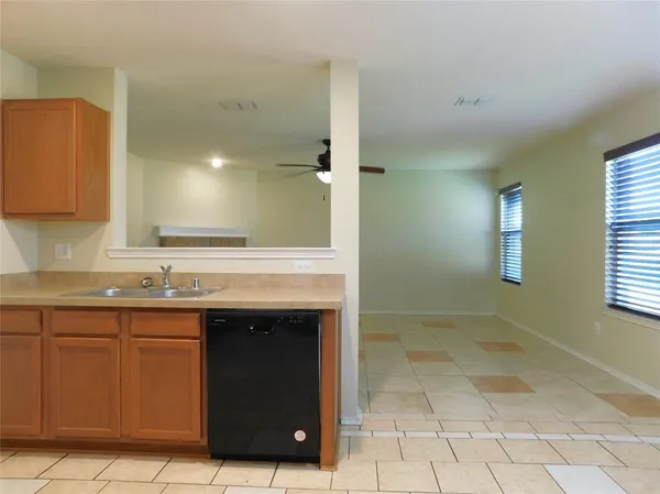 a view of a kitchen with a sink and a window