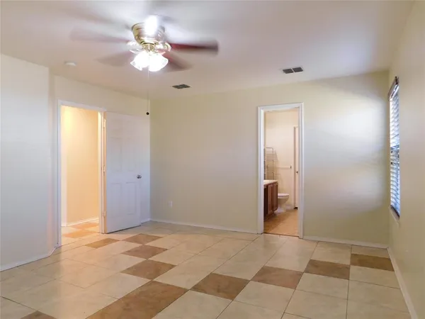 a view of an empty room with a bathroom