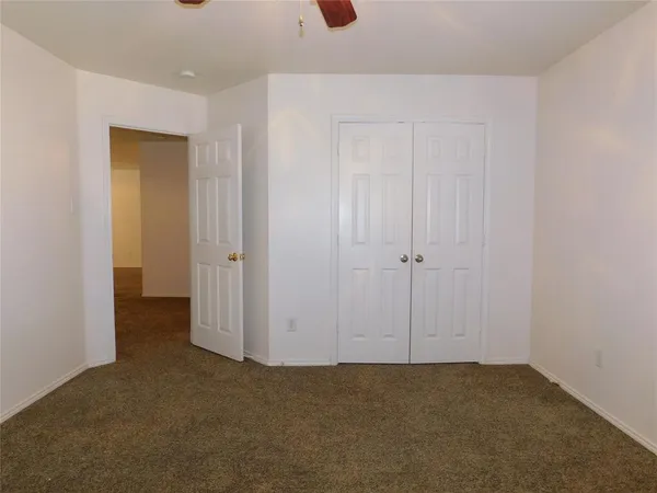 an empty room with closet area