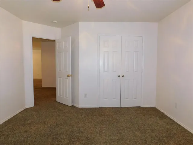 an empty room with closet area