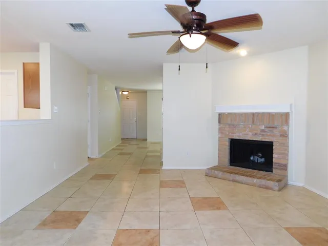a view of an empty room with a fireplace