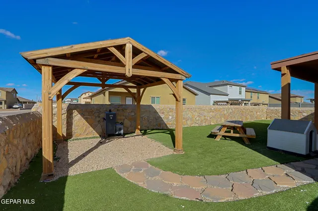 a view of a wooden chairs in a backyard