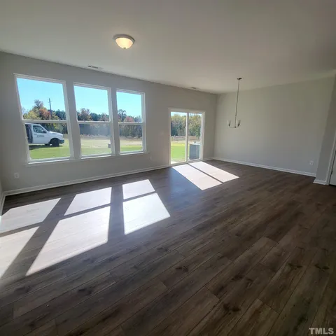 a kitchen with granite countertop a sink stove and cabinets