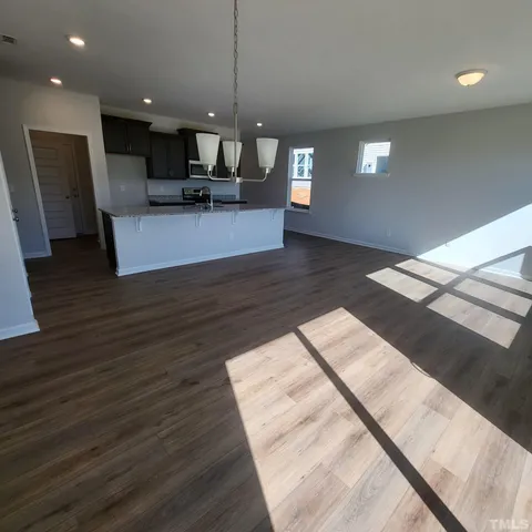 a kitchen with granite countertop a sink stove and cabinets