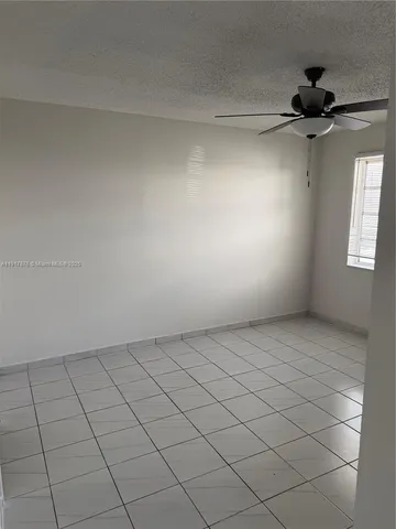 a view of an empty room and a window