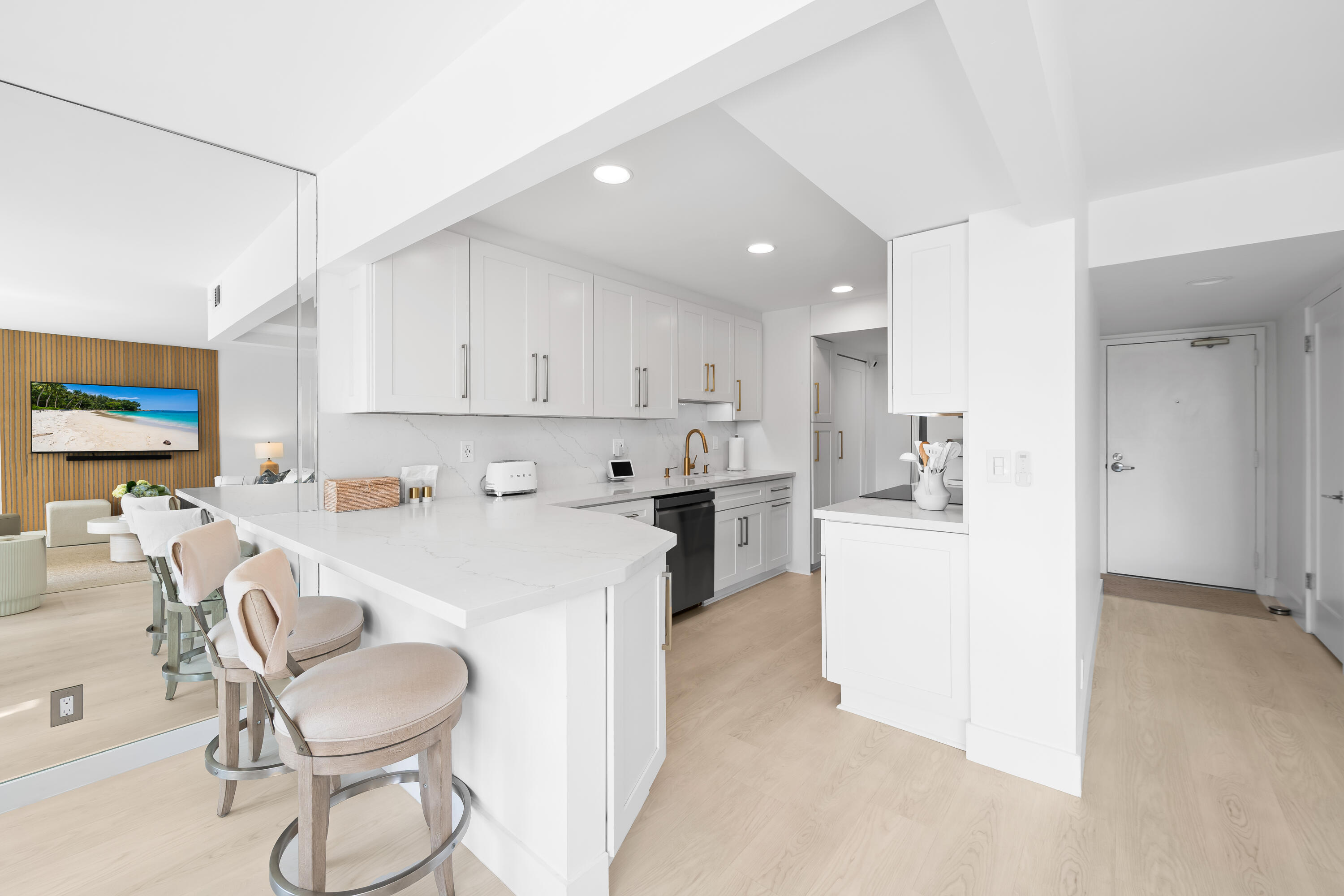 799 Jeffery Street, Unit 303 Boca Raton, FL 33487 - Photo 5 of 42 a kitchen with a dining table chairs sink and white cabinets